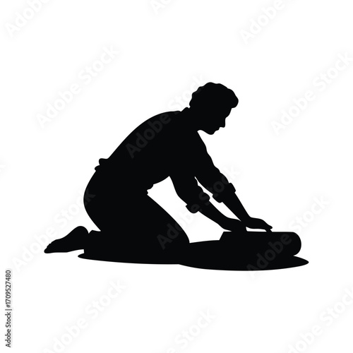 Silhouette of a person kneeling and working on a suitcase or bag, person rolling dough silhouette vector illustration