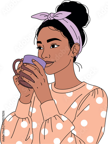 Young woman enjoying a warm drink with a relaxed expression