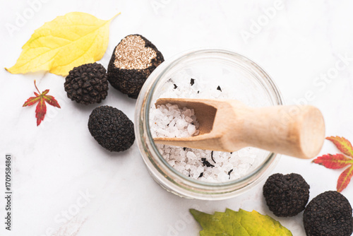 Wallpaper Mural Truffle salt and truffle on the white table with autumn leaves, how to preserve the aroma and taste of black truffle. Preserving black truffle. Delicacy condiment for flavoring dishes Torontodigital.ca