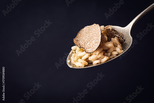 Wallpaper Mural Black truffle risotto recipe. Autumn creamy consistency risotto in spoon, black background Torontodigital.ca