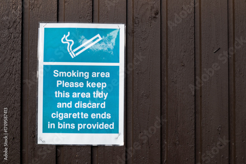 Smoking area sign attached on a wooden wall