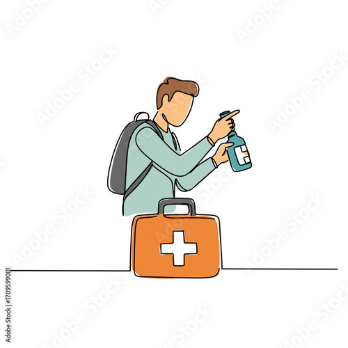 Young man applying disinfectant from bottle beside first aid kit  