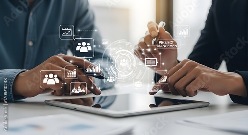 Business team collaborating on tablet with digital project management and communication icons