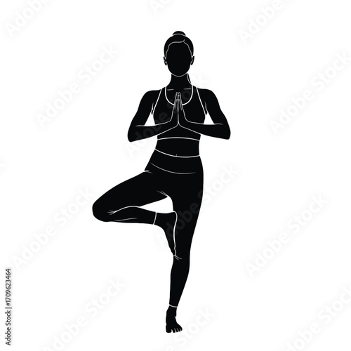 Silhouette of a woman performing tree pose yoga with focused meditation and balance silhouette