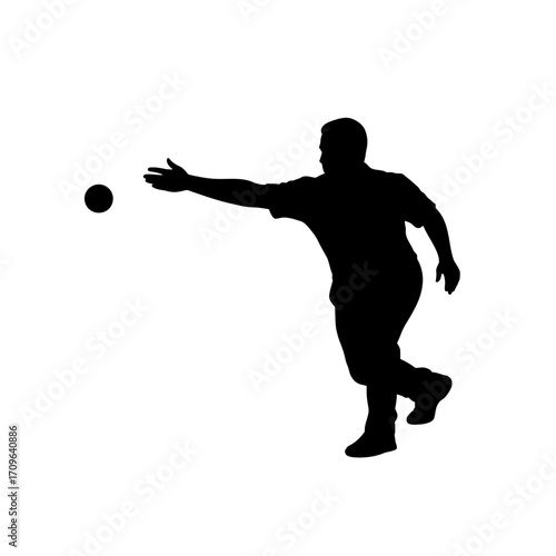 Silhouette of a man throwing a ball during a game of bocce or pétanque action shot