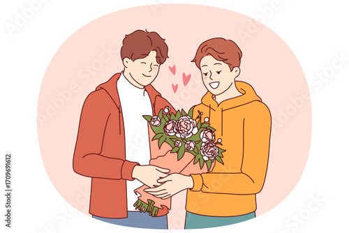 Gay man gives flowers to boyfriend during date and feels safe thanks to society tolerance for LGBT people. Gay guy receives bouquet from lover, on anniversary of relationship or on valentine day