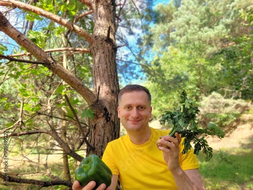 Smiling man holding fresh vegetables