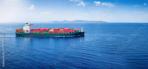Aerial view of a container cargo ship in motion as a concept for transport and industry with copy space © moofushi