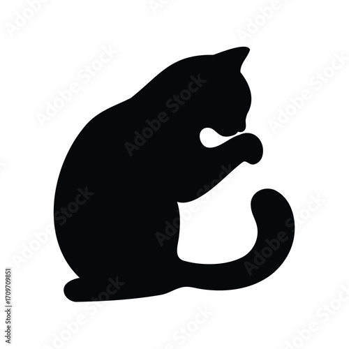 Silhouette of a cat grooming itself with its paw on a white background