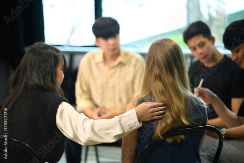 Support group therapy session with diverse participants sharing and offering encouragement