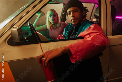 Couple sitting in car at drive thru.