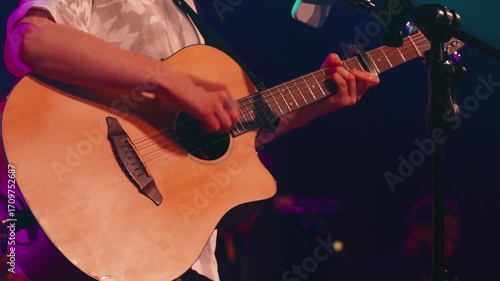 Musician's hands strumming acoustic guitar strings, generating powerful worship music during emotional church service, capturing spiritual moment