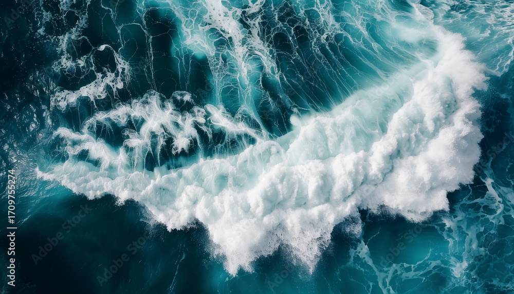 Fototapeta premium Aerial view of ocean wave with foamy white crests