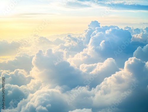 High-altitude view of fluffy clouds illuminated by golden sunlight