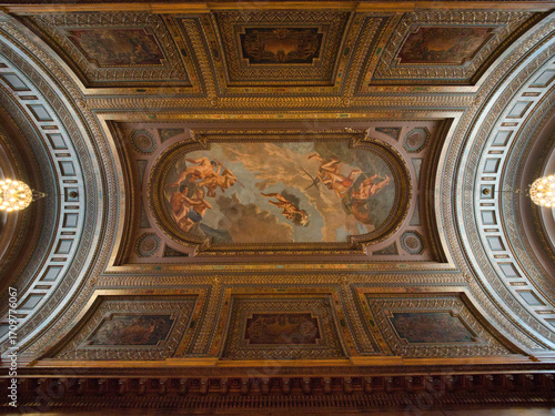 New York Public Library Ceiling Mural - A low-angle view of the highly ornate, painted ceiling with classical murals and intricate decorative patterns inside the New York Public Library.