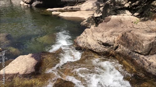 Water current of a small river ending in a small pond, clean and crystal clear water, mountain environment, Geres mountain, Portugal
