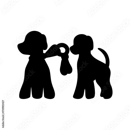 Silhouette of two dogs playing tug of war with a rope toy