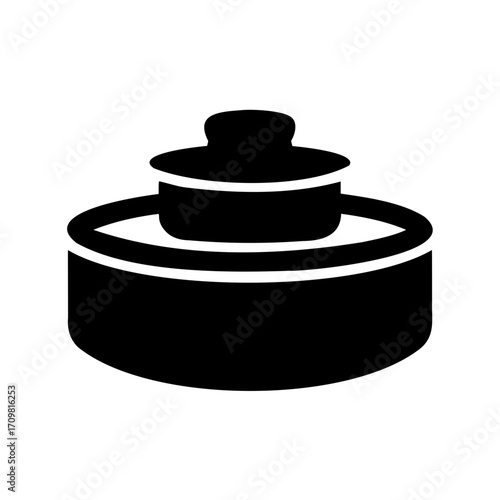 An unusual object stands alone featuring an elevated upper level component
