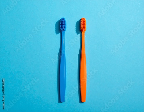 Color-Paired Toothbrushes on Blue Backdrop
