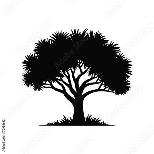 Silhouette of a majestic tree with lush foliage and grass clumps isolated