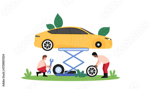 Two mechanics changing a tire on a yellow car lifted by a hydraulic car lift.