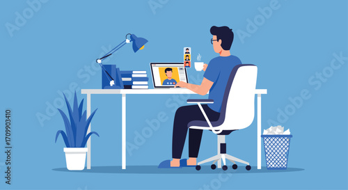 Young man focused working on laptop at modern desk with lamp plant and office supplies