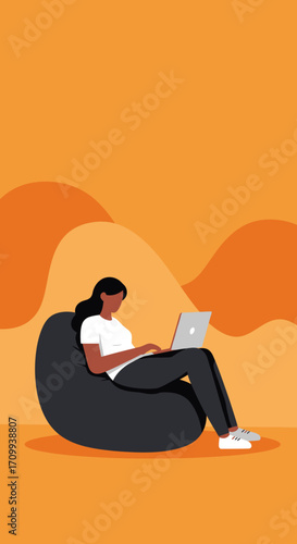 Young woman working on laptop from a comfortable beanbag chair. Ideal for remote work, freelance, or online learning concepts.