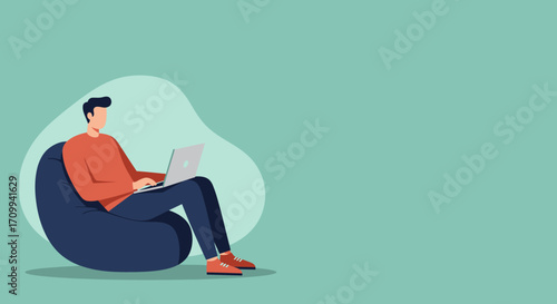 Young man working remotely on a laptop from the comfort of a bean bag chair. Illustrates flexible work, freelance lifestyle, and modern technology use.