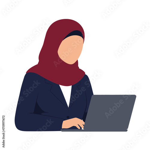 A woman in a hijab and business suit working on a laptop.