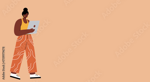 Young Black woman uses a laptop on a peach background, representing remote work, online learning, or digital connection.