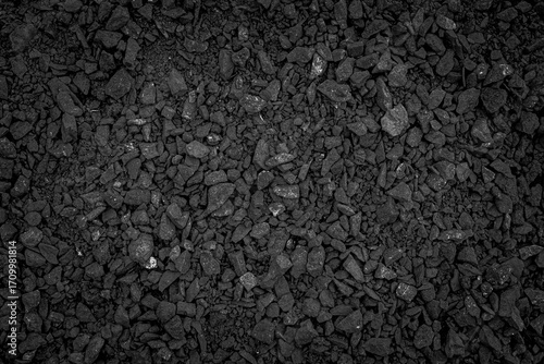 Photo of Big pile of natural black coals. Background texture for backdrops or mapping.Preparation and Laying of asphalt. Textured background. Construction industry.