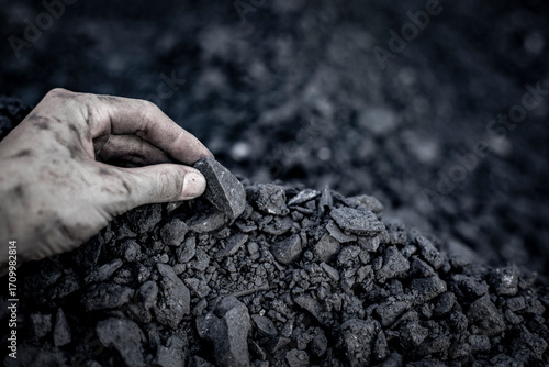 Black coal in hand. Thermal energy industry. Heating. Mineral raw materials. Natural energy stones.