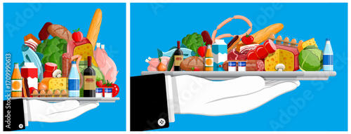 Man hand holding silver tray with groceries, fresh food and drink product. Supermarket store, organic healthy eating concept.