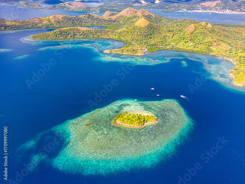 Turquoise clear water with coral reefs around in CYC Beach. Coron, Palawan. Philippines.