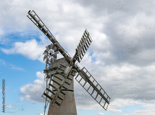 Historic windmill with sails in the Norfolk countryside