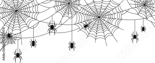 Spooky Halloween spiderwebs with dangling spiders create a festive and eerie holiday atmosphere.
