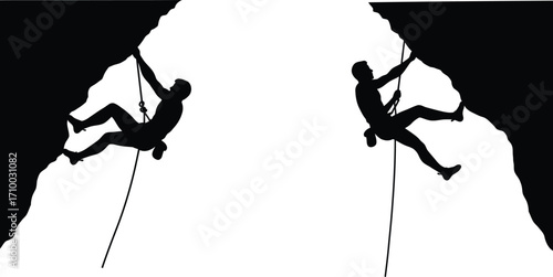 Two silhouetted climbers scaling opposite rock faces a study in contrast