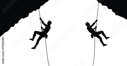 Two silhouetted climbers rappelling down from cliffs in a stark landscape