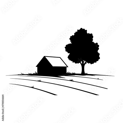 Rustic barn and mature tree silhouetted against a bright sky in a rural landscape