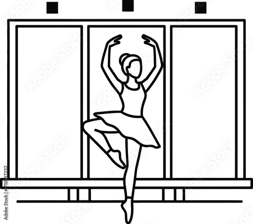 Graceful ballerina performing a delicate dance pose against a backdrop of windows.