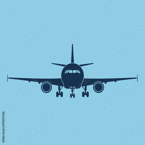 Front view of a dark blue commercial airplane with landing gear deployed against a light blue sky background