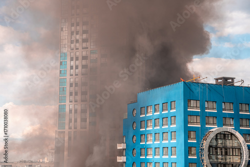 Cuadro en lienzo Thick smoke engulfing residential buildings creates a dramatic scene after a fir