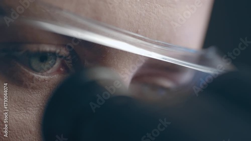 Female virologist scientist using microscope in laboratory. Biochemical and medical research. Pharmacist specialist working with lab equipment analyzing samples and searching for vaccine development