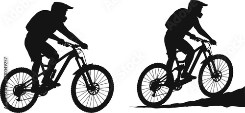 Two mountain bikers in silhouette ride uphill on a trail