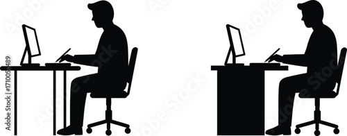 Silhouette of two people working on computers at desks side view