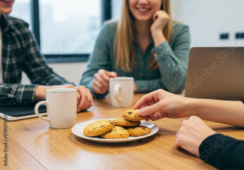 Colleagues Sharing Homemade Cookies in Office Break Room. National Homemade Cookies Day
