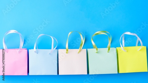 Colorful Shopping Bags on Blue Background for Retail and Sales