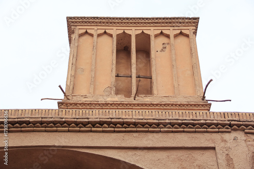 Historic windcatcher and adobe house in Yazd, Iran, showcasing traditional Persian desert architecture and cultural heritage.