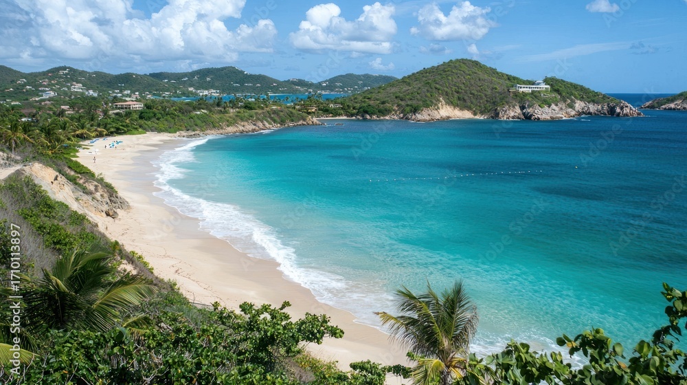 Fototapeta premium Scenic Caribbean beach with turquoise water, white sand, and lush greenery.