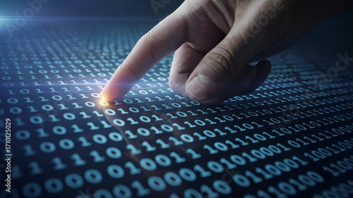 Closeup of a finger touching a glowing stream of binary code on a digital screen, representing data, programming and digital world